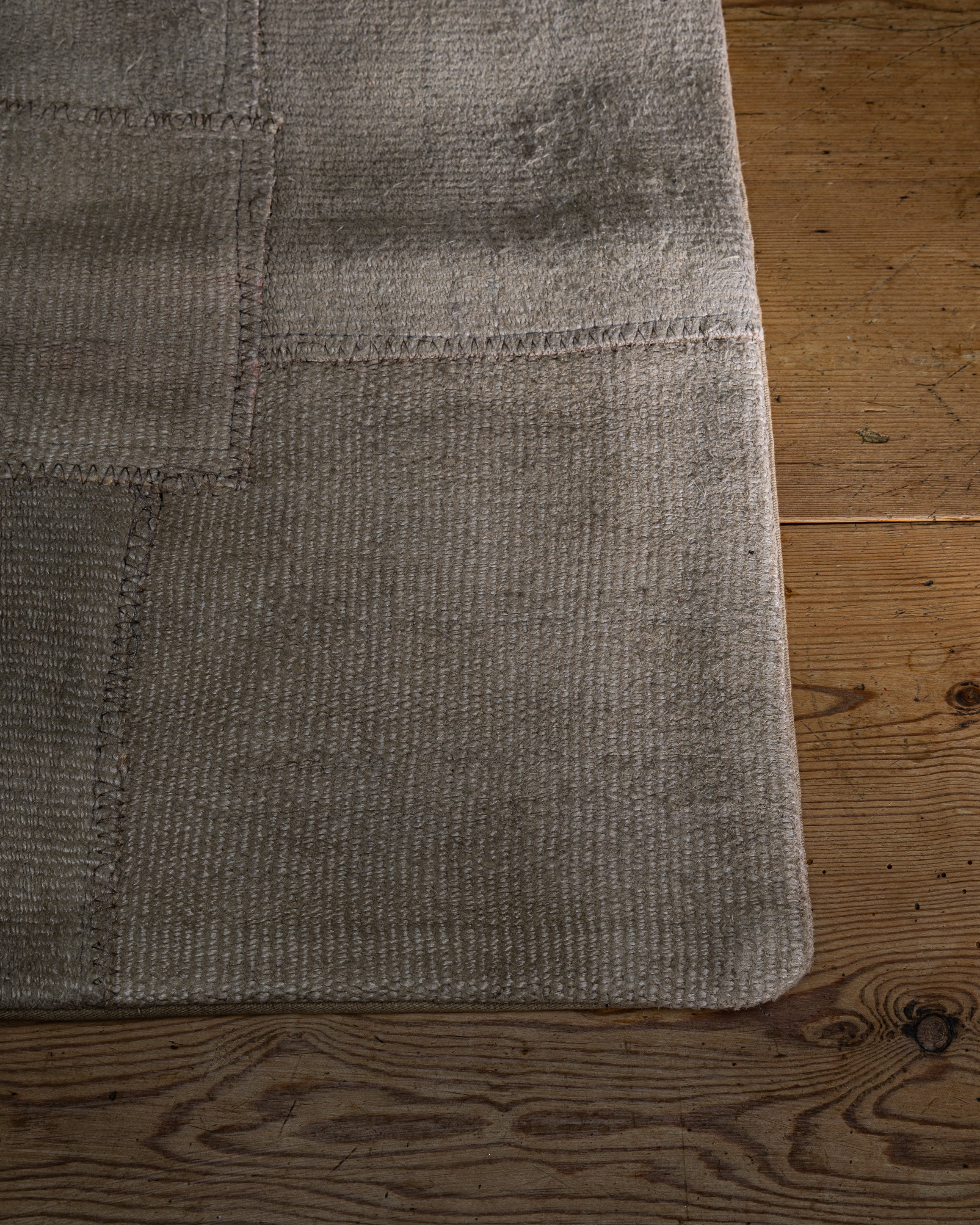Nærbilde av hjørne på et kelim putetrekk i beige for å se den grove strukturen i stoffet 