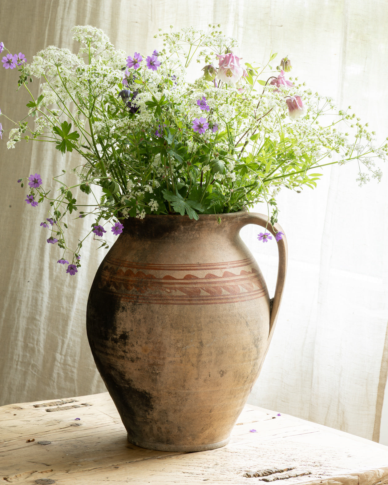 krukke-med-blomster-paa-bord